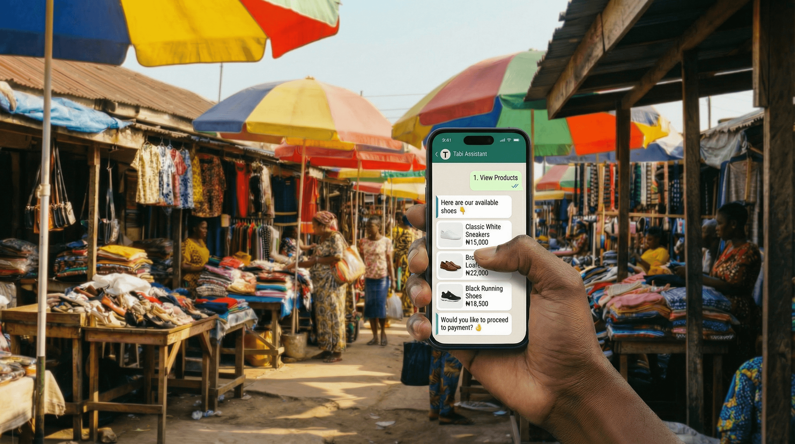 Hand holding a phone with Tabi Assistant in an African market